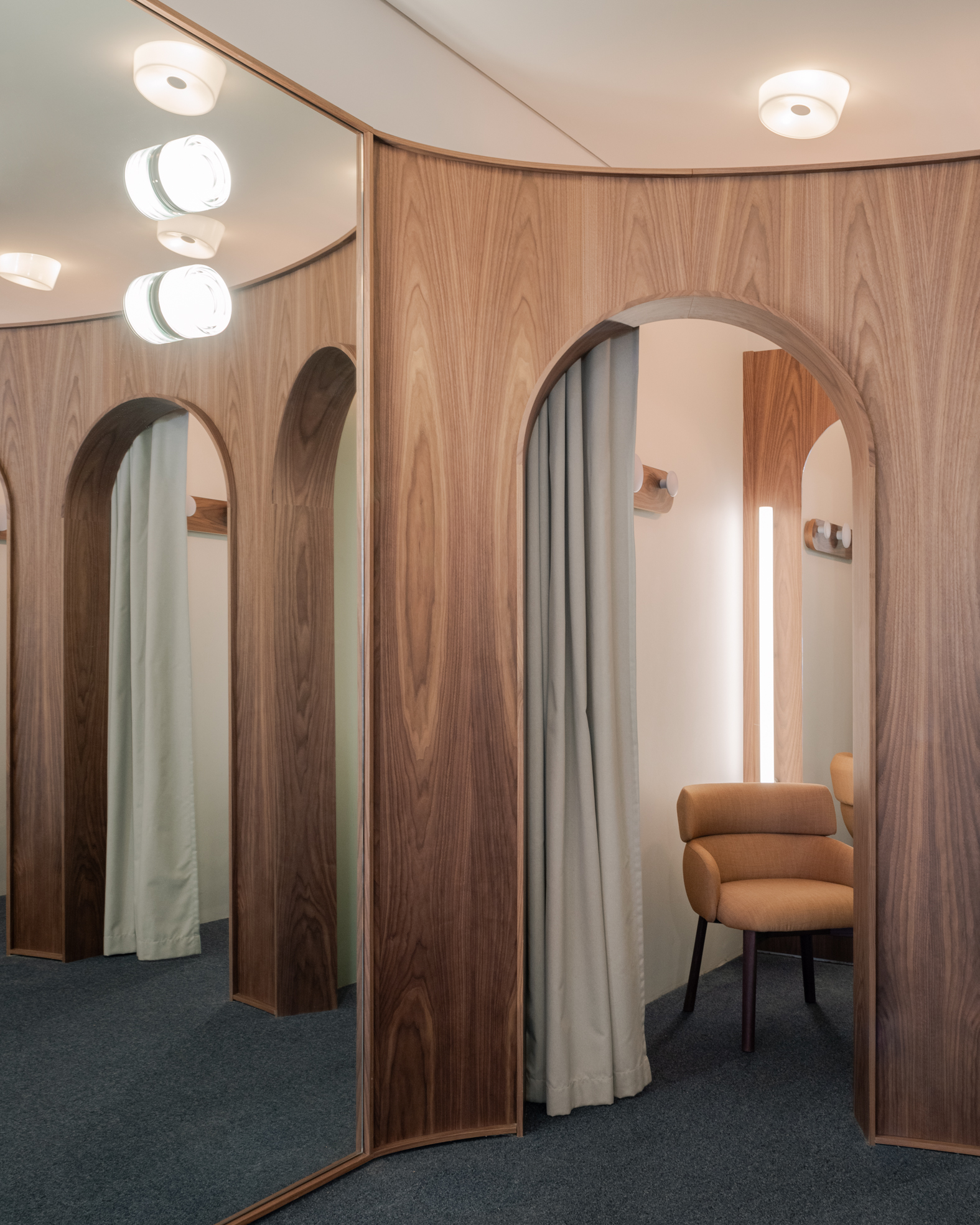 Fitting rooms of a quiet luxury menswear shop.