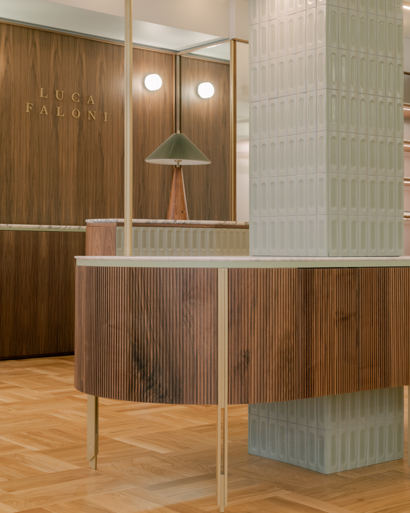 Detail of a custom-made piece of furniture in wood and green tiles.